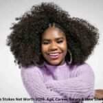 Trinitee Stokes smiling in a purple sweater – Trinitee Stokes Net Worth 2026
