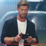 Chris Hemsworth net worth 2026 holding a device in a scene