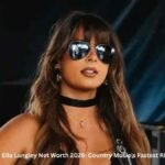Ella Langley Net Worth – Country singer Ella Langley wearing sunglasses while performing on stage in 2026.