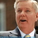 Lindsey Graham speaking at a microphone, featured in an article about Lindsey Graham Net Worth and his financial background.