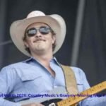 Zach Top performing live on stage with a guitar during a country music concert – Zach Top Net Worth