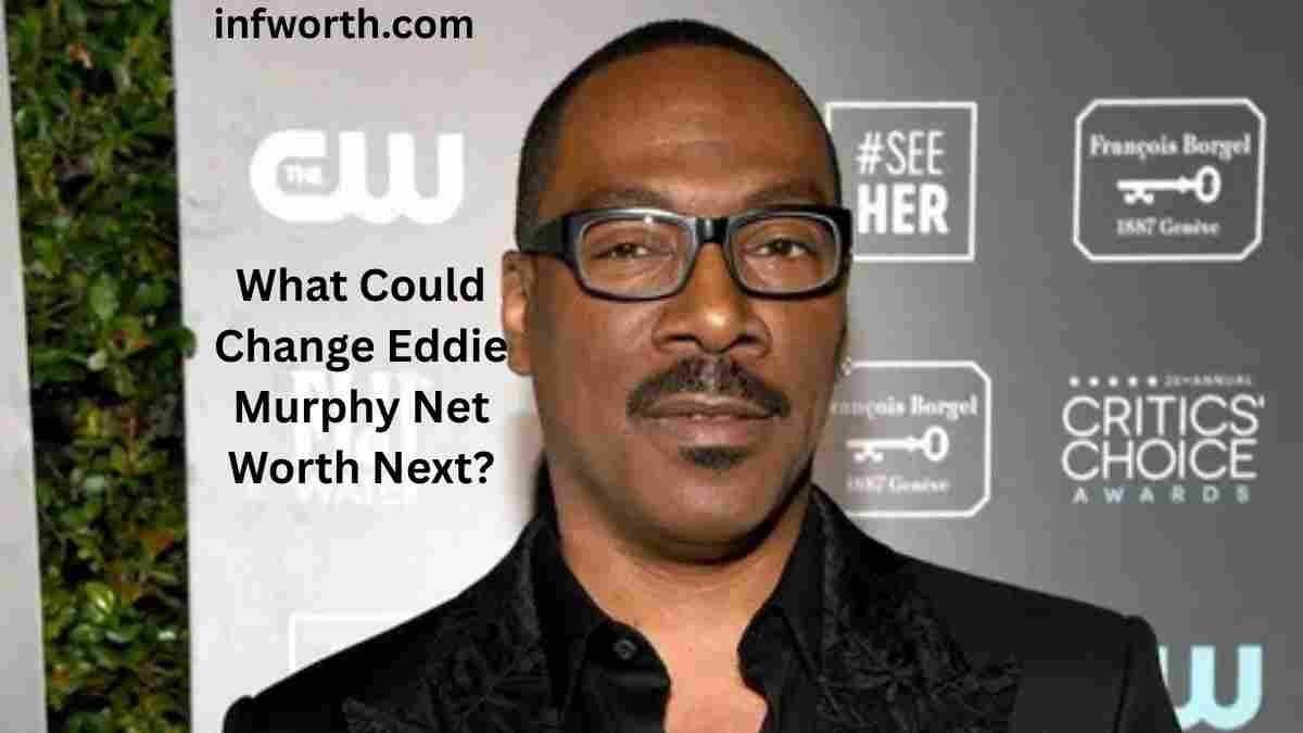 Eddie Murphy Net Worth – actor wearing black glasses and a black suit at an awards event.